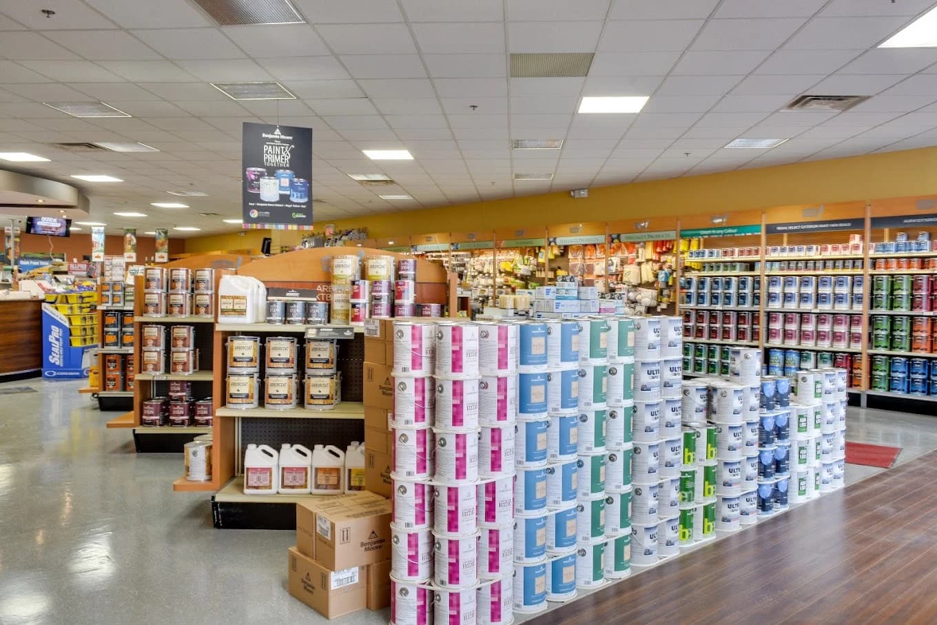 Paint store interior with Benjamin Moore paint displays and stocked shelves